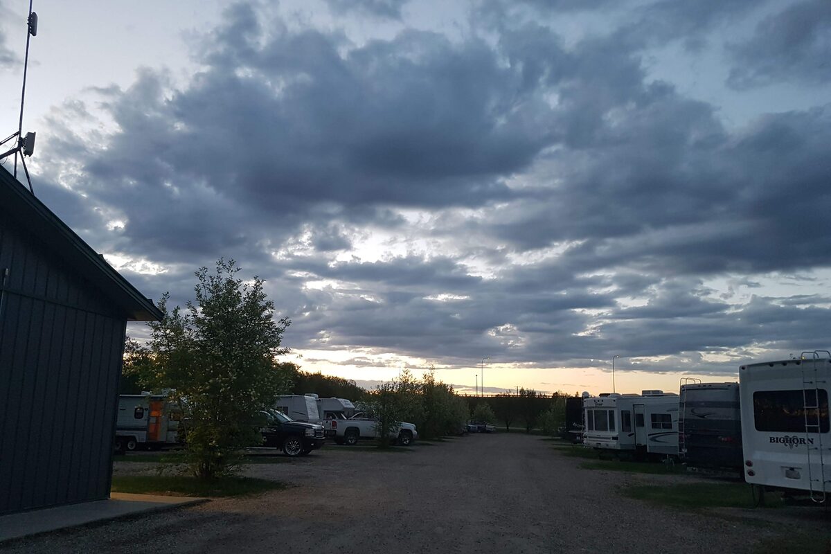Dramatic evening sky over Edson RV Park with RVs silhouetted against clouds
