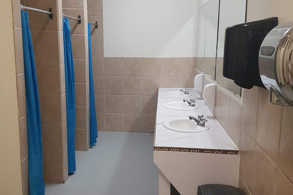 Clean washroom facilities with tiled shower stalls and sinks at Edson RV Park