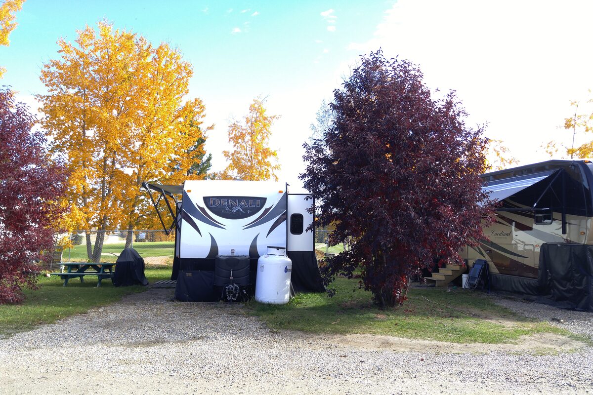 RV trailers with fall foliage including Denali and Cardinal models at sites next to golf course